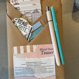 an envelope with paper and pens